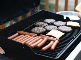 Pølser og burgere på en grill